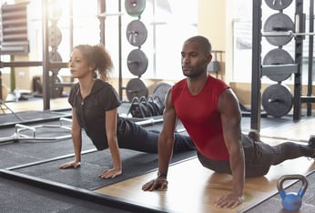 man-and-woman-doing-yoga-stretch-in-a-gym-royalty-free-image-479760469-1540325200 (2)